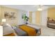 Inviting bedroom with soft yellow walls, ceiling fan, natural light and comfortable bed at 7200 Grace Rd, Orlando, FL 32819