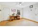 Bright bedroom featuring a ceiling fan, wood floors, and a cozy desk area by the window at 7200 Grace Rd, Orlando, FL 32819