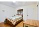 Simple bedroom featuring hardwood floors and a full sized bed with wooden frame at 7200 Grace Rd, Orlando, FL 32819