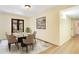 Elegant dining room featuring a modern table with seating for six, complemented by stylish decor and hardwood floors at 7200 Grace Rd, Orlando, FL 32819