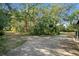 View of the circular driveway, surrounded by lush greenery and mature trees at 7200 Grace Rd, Orlando, FL 32819