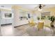 Open concept kitchen featuring white appliances, a ceiling fan, and a breakfast nook with backyard views at 7200 Grace Rd, Orlando, FL 32819