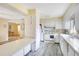 Well-lit kitchen featuring white cabinets, modern appliances, and a breakfast bar overlooking a dining area at 7200 Grace Rd, Orlando, FL 32819