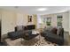 Staged living room with grey couches, light-colored flooring, and access to an outdoor porch at 7200 Grace Rd, Orlando, FL 32819