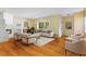 Bright living room featuring wood floors, fireplace, modern furniture, and a large window with natural light at 7200 Grace Rd, Orlando, FL 32819