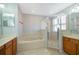 Bathroom featuring a soaking tub, glass-enclosed shower, and double sinks at 11313 Via Andiamo, Windermere, FL 34786