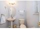 Cozy bathroom with pedestal sink, toilet, and decorative accents at 11313 Via Andiamo, Windermere, FL 34786