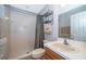 Bathroom featuring a step-in shower, single sink vanity and metal shelving unit at 11313 Via Andiamo, Windermere, FL 34786