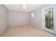 Bright bedroom with a ceiling fan and a door to a balcony with a garden view at 11313 Via Andiamo, Windermere, FL 34786