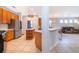 Open kitchen with stainless steel appliances and a view into the adjacent living space at 11313 Via Andiamo, Windermere, FL 34786