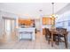 Open floor plan with tile flooring and a dining area off the kitchen with natural light at 11313 Via Andiamo, Windermere, FL 34786