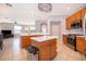Well-lit kitchen featuring an island with white countertop and stainless steel appliances at 11313 Via Andiamo, Windermere, FL 34786
