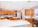 A bright kitchen with wooden cabinets, stainless steel appliances, white countertops and a breakfast nook at 11313 Via Andiamo, Windermere, FL 34786