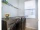 Laundry room with a side-by-side washer and dryer, plus overhead shelving at 11313 Via Andiamo, Windermere, FL 34786