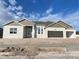 Charming single-story home featuring a two-car garage and stone accents on the facade, set against a beautiful sky at 2556 Hawks Overlook Pl, Oviedo, FL 32765