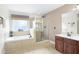 Elegant bathroom with double vanity, soaking tub, and separate shower at 555 Carey Way, Orlando, FL 32825