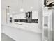 Modern kitchen featuring sleek white cabinetry, marble countertops, and stainless steel appliances at 1315 Wheeler Rd, Apopka, FL 32703
