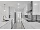 Modern kitchen showcasing white cabinetry, marble backsplash, and stainless steel appliances at 1315 Wheeler Rd, Apopka, FL 32703