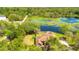 Aerial shot of a house close to a lake surrounded by lush greenery and trees at 45 Sackett Rd, Debary, FL 32713