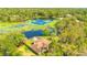 An aerial view of the property shows it nestled amongst trees with access to a lake at 45 Sackett Rd, Debary, FL 32713