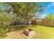 Backyard with a brick fire pit and wooden privacy fence, offering a serene outdoor space at 45 Sackett Rd, Debary, FL 32713