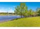 Picturesque backyard with a lush lawn extending to a calm lake at 45 Sackett Rd, Debary, FL 32713