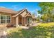 Attractive single-Gathering home with a well-manicured lawn and pathway to outbuildings at 45 Sackett Rd, Debary, FL 32713