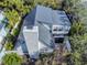 Aerial view of the home with a modern roof and chimney, nestled in lush greenery at 6353 River Rd, New Smyrna Beach, FL 32169