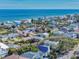Stunning aerial view highlights beach homes in a coastal neighborhood, offering a glimpse of seaside living and beautiful ocean vistas at 6353 River Rd, New Smyrna Beach, FL 32169