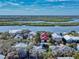 Overhead view of a residential area near a waterway and estuary, with various homes and lush greenery at 6353 River Rd, New Smyrna Beach, FL 32169