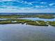 Vibrant aerial view showcases the waterways, estuaries, and lush natural landscape surrounding the coastal community at 6353 River Rd, New Smyrna Beach, FL 32169