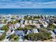 An aerial view showcases oceanfront homes in a coastal community with stunning ocean views at 6353 River Rd, New Smyrna Beach, FL 32169