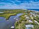 A scenic aerial view of a coastal community, highlighting waterfront living amidst a rich ecosystem of waterways and marshes at 6353 River Rd, New Smyrna Beach, FL 32169
