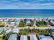 Aerial view of a coastal community featuring oceanfront homes with stunning beach access and neighborhood streets at 6353 River Rd, New Smyrna Beach, FL 32169