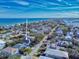 Beautiful aerial view of a coastal home with ocean access and lush tropical landscaping at 6353 River Rd, New Smyrna Beach, FL 32169