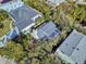 Aerial view of charming home with a new roof, surrounded by lush trees at 6353 River Rd, New Smyrna Beach, FL 32169