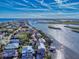 An aerial view of waterfront homes along a river, highlighting the tranquil community and beautiful scenery at 6353 River Rd, New Smyrna Beach, FL 32169