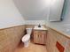 Tiled bathroom with a modern sink vanity, a sleek faucet, a toilet and bright natural light at 6353 River Rd, New Smyrna Beach, FL 32169