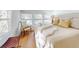 Serene bedroom with a plush bed, side chair, and large windows offering natural light at 6353 River Rd, New Smyrna Beach, FL 32169