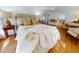 Bright bedroom with wood floors, large bed with stylish pillows, and sitting area at 6353 River Rd, New Smyrna Beach, FL 32169