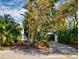 Home exterior with a long driveway and lush landscaping at 6353 River Rd, New Smyrna Beach, FL 32169