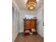 Hallway featuring an attractive light fixture, decorative cabinet and closet for storage at 6353 River Rd, New Smyrna Beach, FL 32169