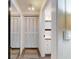 Hallway with large closet, lighting, and a view of the adjacent bathroom at 6353 River Rd, New Smyrna Beach, FL 32169