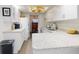 Bright, modern kitchen with white cabinets, granite countertops and plenty of natural light at 6353 River Rd, New Smyrna Beach, FL 32169