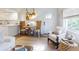 Cozy living space featuring a white chair, wood accents, and natural light at 6353 River Rd, New Smyrna Beach, FL 32169
