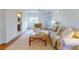 Cozy living room with light hardwood floors, a comfortable sofa, and a view into the bathroom at 6353 River Rd, New Smyrna Beach, FL 32169