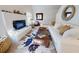 Inviting living room with modern decor, including a white brick fireplace and comfortable seating arrangements at 6353 River Rd, New Smyrna Beach, FL 32169