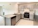 Modern kitchen with gray cabinets, stainless steel appliances, and light countertops at 791 Chinoy Rd, Davenport, FL 33837