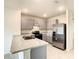 Modern kitchen with stainless steel appliances and gray cabinets at 791 Chinoy Rd, Davenport, FL 33837