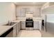 Modern kitchen with gray cabinets, stainless steel appliances and granite countertops at 791 Chinoy Rd, Davenport, FL 33837